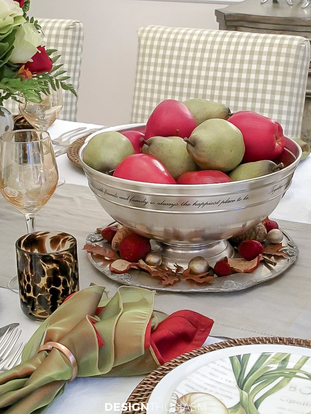 apples and pears in a silver fruit bowl